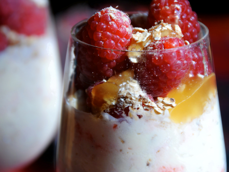 Traditional Cranachan dessert with raspberries, whipped cream, honey, and toasted oats