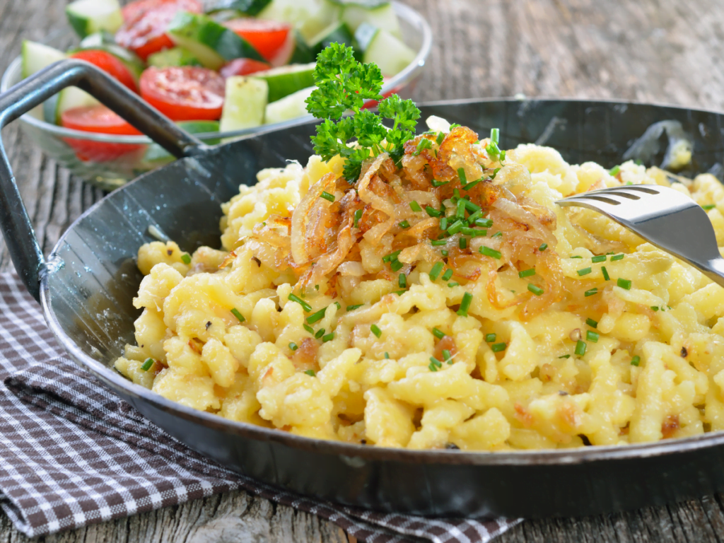 raditional German Käsespätzle with melted cheese and crispy onions