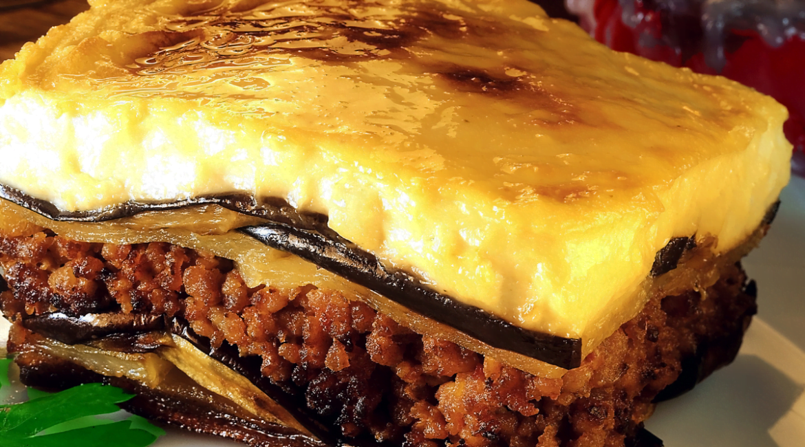 Traditional Greek moussaka with eggplant, seasoned meat, and béchamel sauce