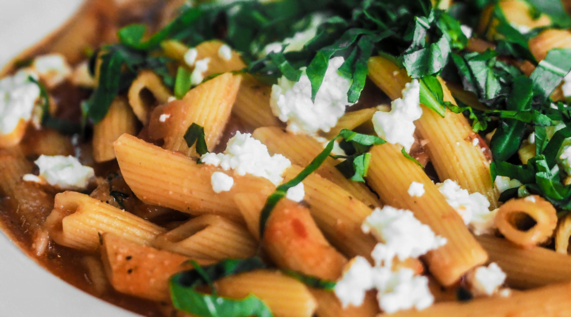 Pasta salad with feta cheese, fresh vegetables, and light vinaigrette