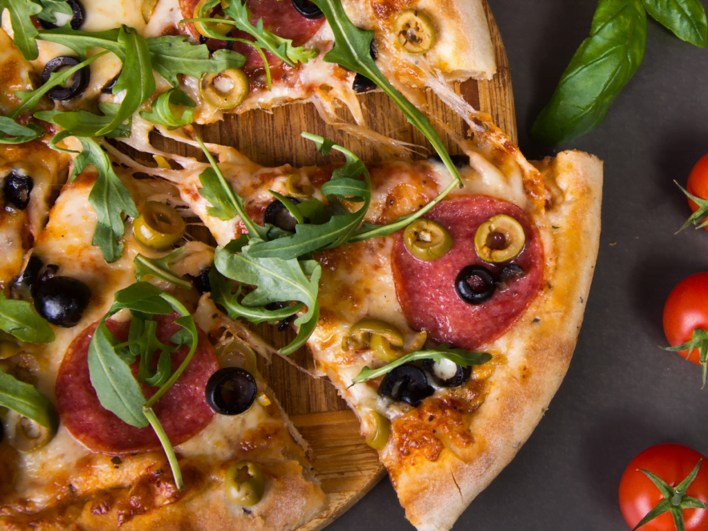 Rucola pizza with tomato sauce, melted mozzarella, and fresh arugula