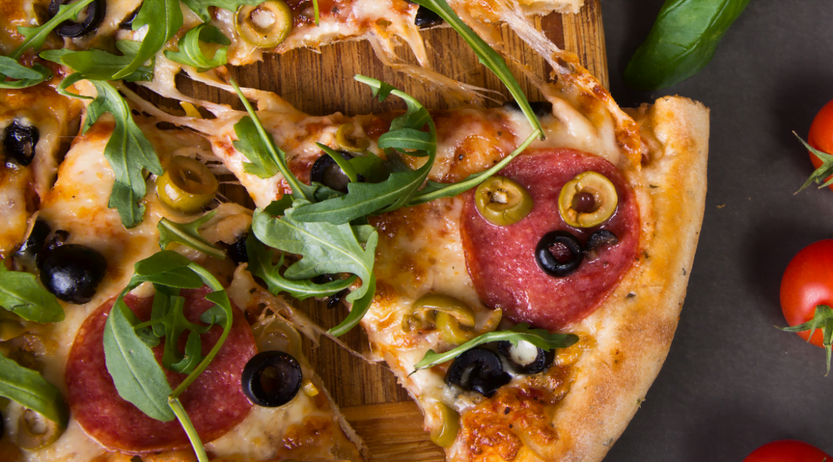 Rucola pizza with tomato sauce, melted mozzarella, and fresh arugula