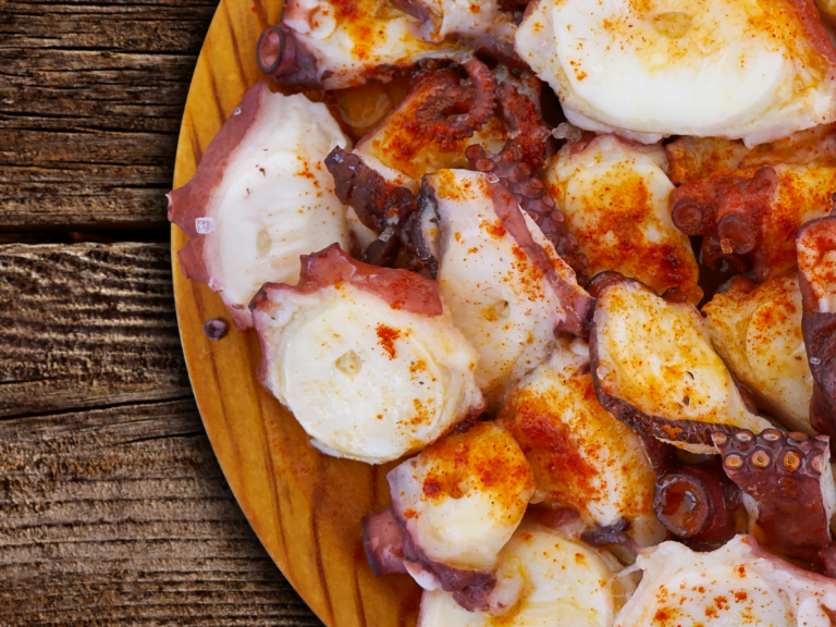 Traditional Spanish Pulpo a la Gallega with octopus, olive oil, paprika, and coarse salt