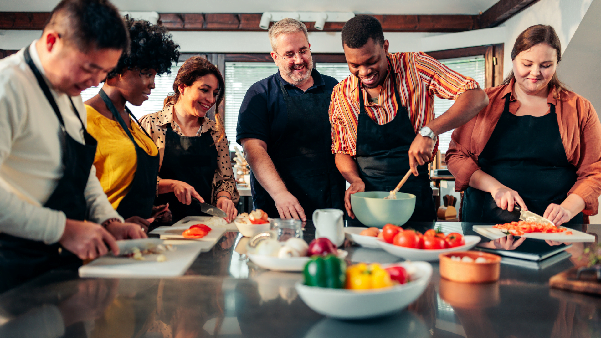 Group of people cooking together, embodying the discovery of a destination's soul through culinary traditions, highlighting the joy of sharing food and travel experiences with loved ones
