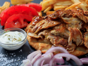 Authentic Greek gyros with marinated meat, fresh vegetables, and tzatziki sauce