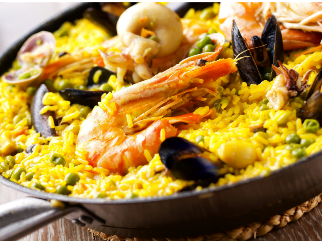 Traditional Spanish paella with saffron rice, seafood, meats, and vegetables