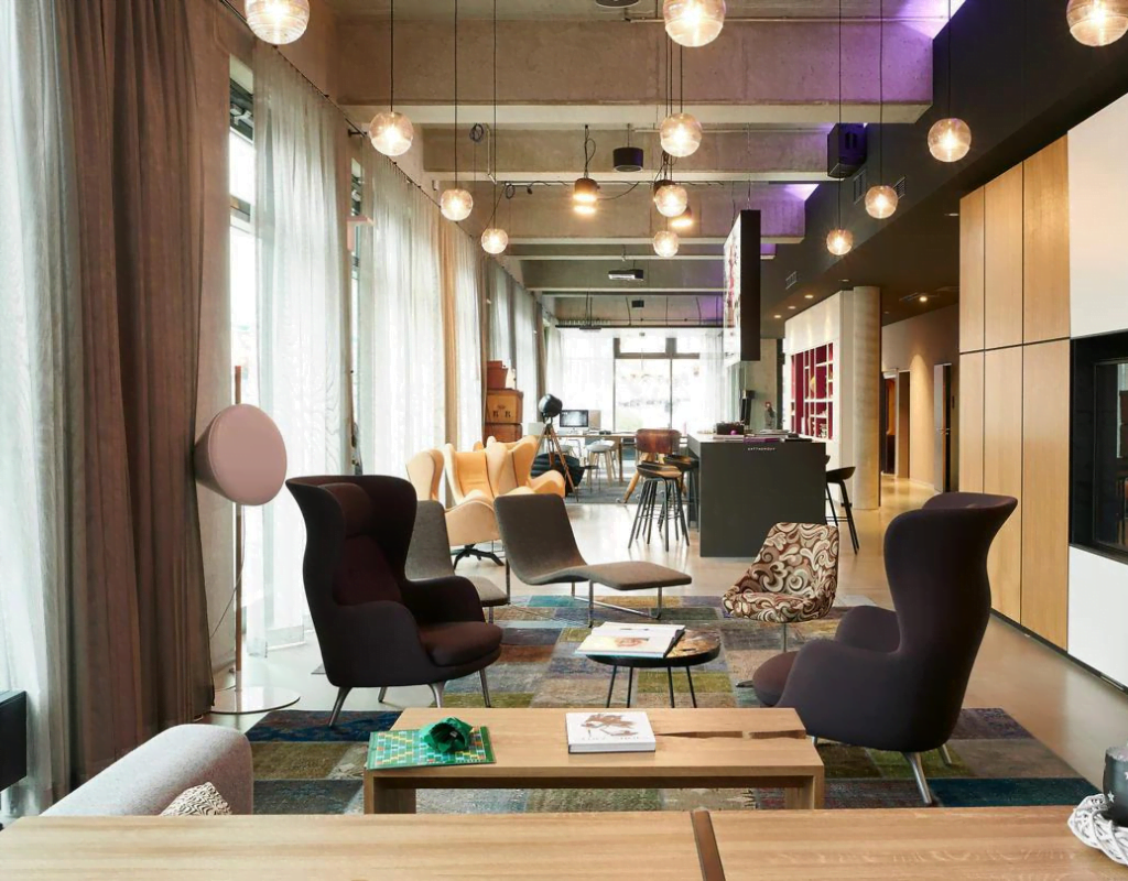 Lobby of Moxy Berlin Ostbahnhof with vibrant decor and modern furnishings