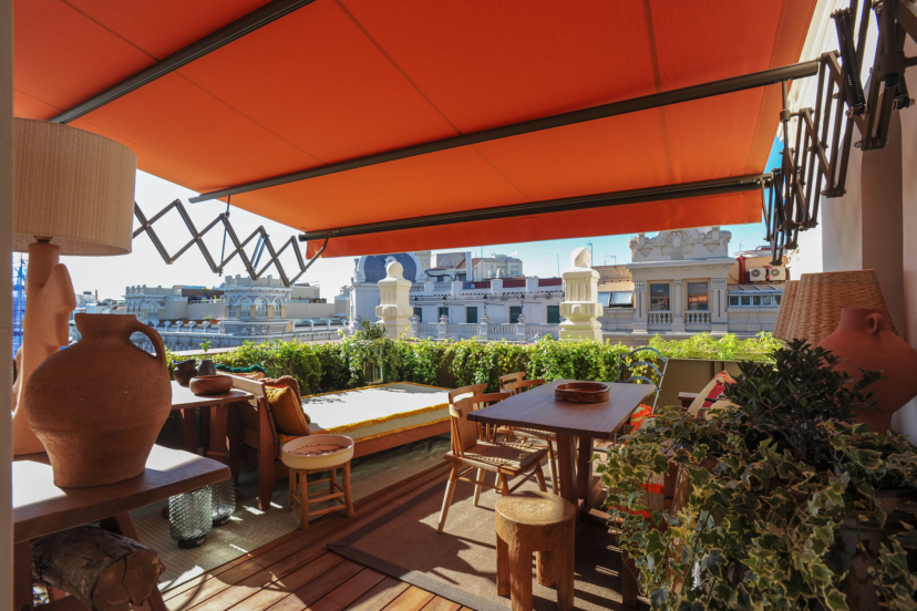 Terrace of Brach Madrid with a stunning view of the Madrid skyline in the background.