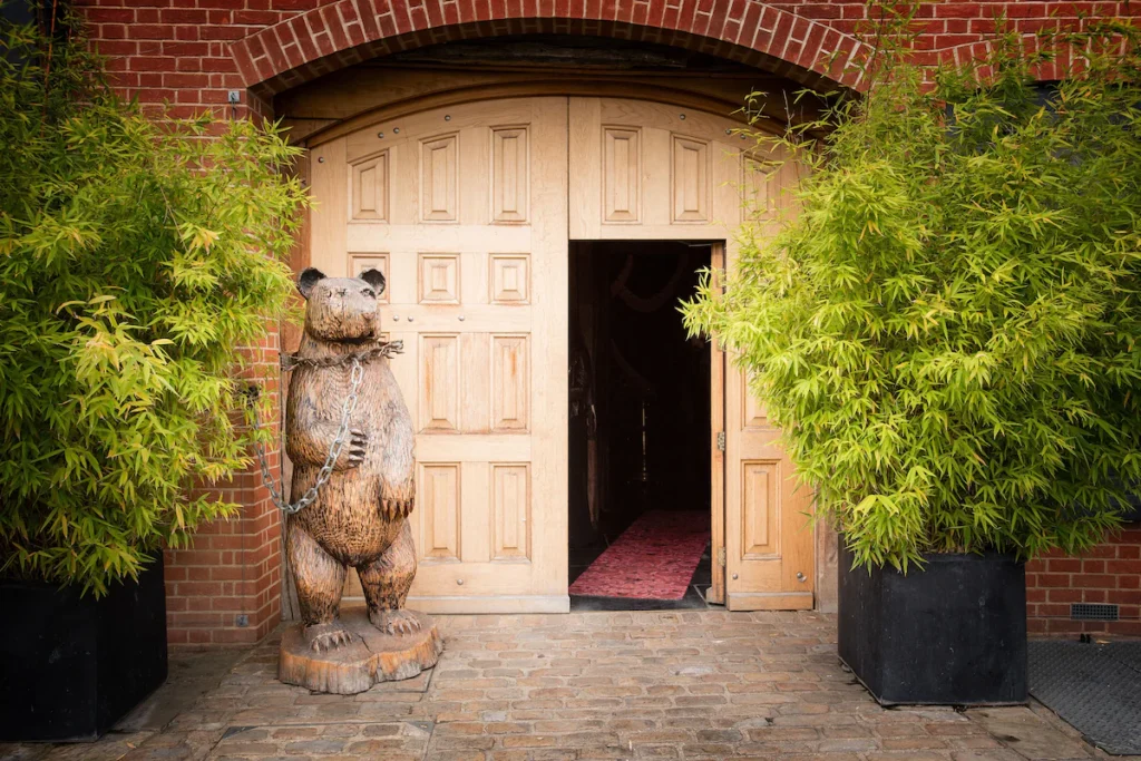 Crazy Bear Hotel in Beaconsfield - Entrance with wooden bear sculpture.