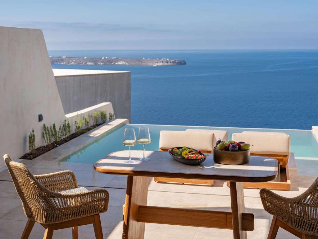 View from a balcony at Santo Mine Oia Suites, overlooking the Aegean Sea with a serene, unobstructed ocean horizon.