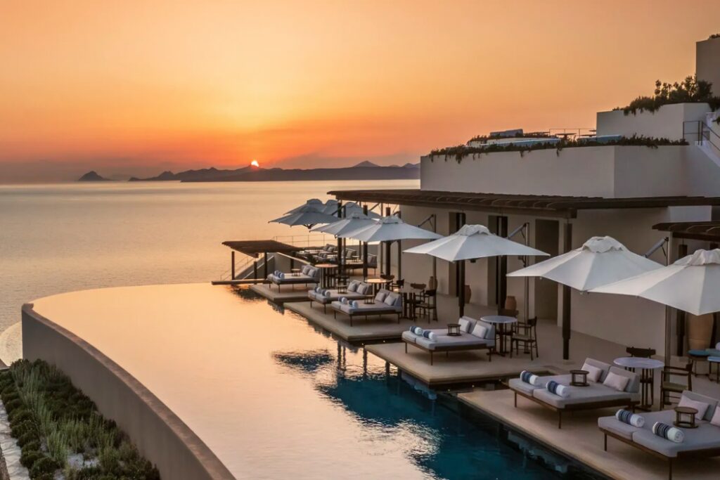 Terrace of One&Only Kéa Island at sunset, overlooking the Aegean Sea with a warm, golden glow.