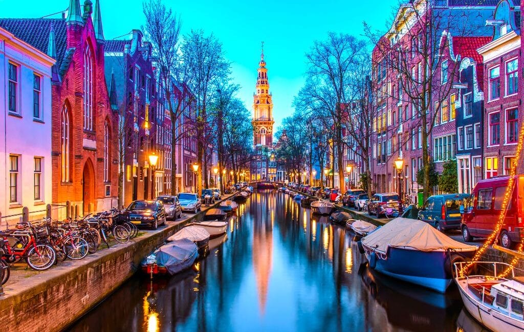 Amsterdam canals with LGBTQ flags, showcasing the city's inclusivity and charm