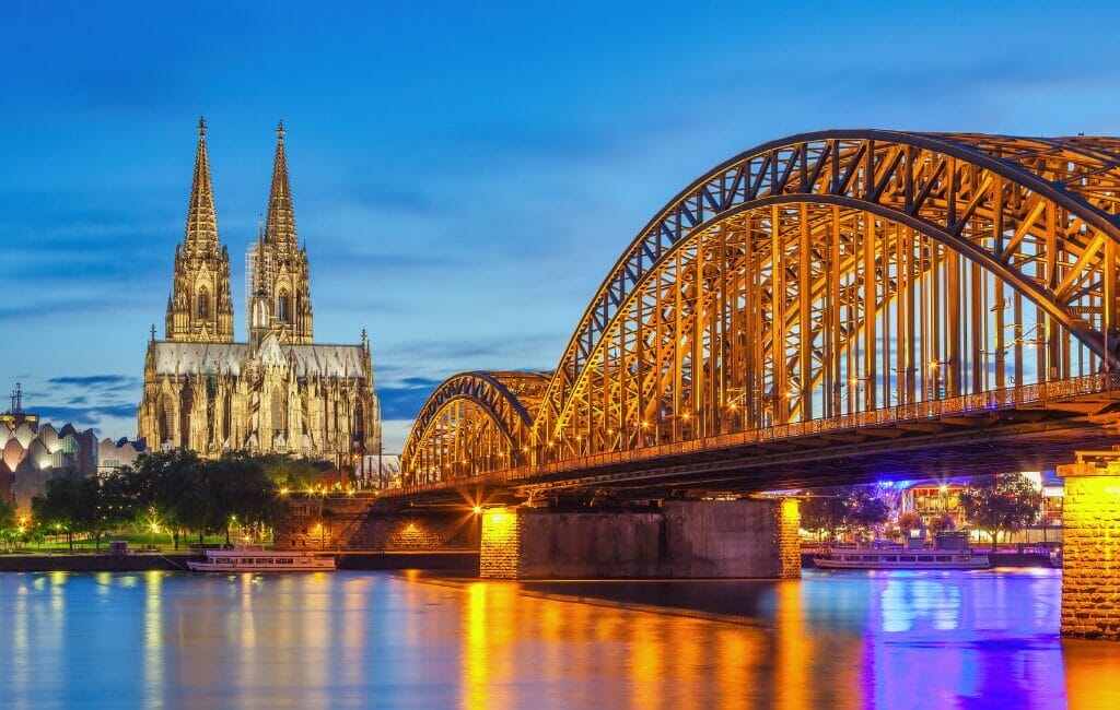 LGBTQ flags in Cologne, Germany, welcoming American LGBTQ travelers with open arms.