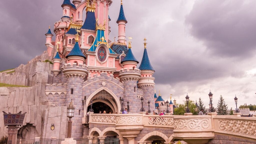 Sleeping Beauty Castle at Disneyland Paris during sunset.