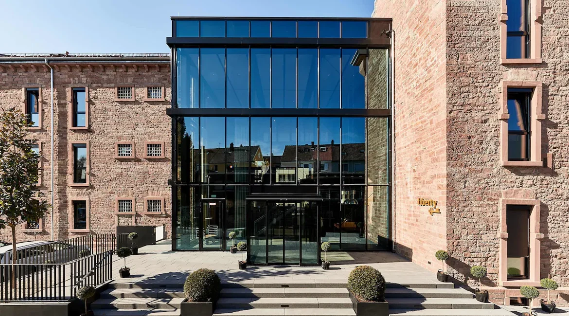 Exterior view of Liberty Hotel in Offenburg, a former prison turned luxury hotel