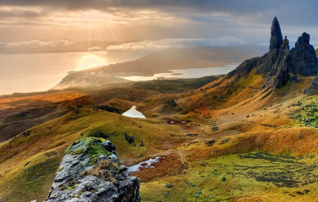 Scenic landscape of the Isle of Skye with rugged mountains and lush greenery.