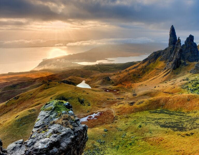 Scenic landscape of the Isle of Skye with rugged mountains and lush greenery.