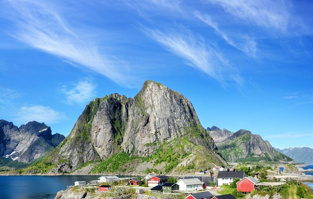 Scenic view of Lofoten with water in the foreground and towering mountains in the background