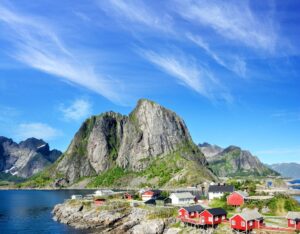 Scenic view of Lofoten with water in the foreground and towering mountains in the background