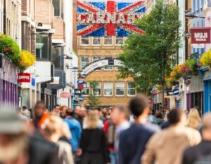 LGBTQ community celebrating in the vibrant streets of London's Soho, showcasing the city's inclusive spirit.