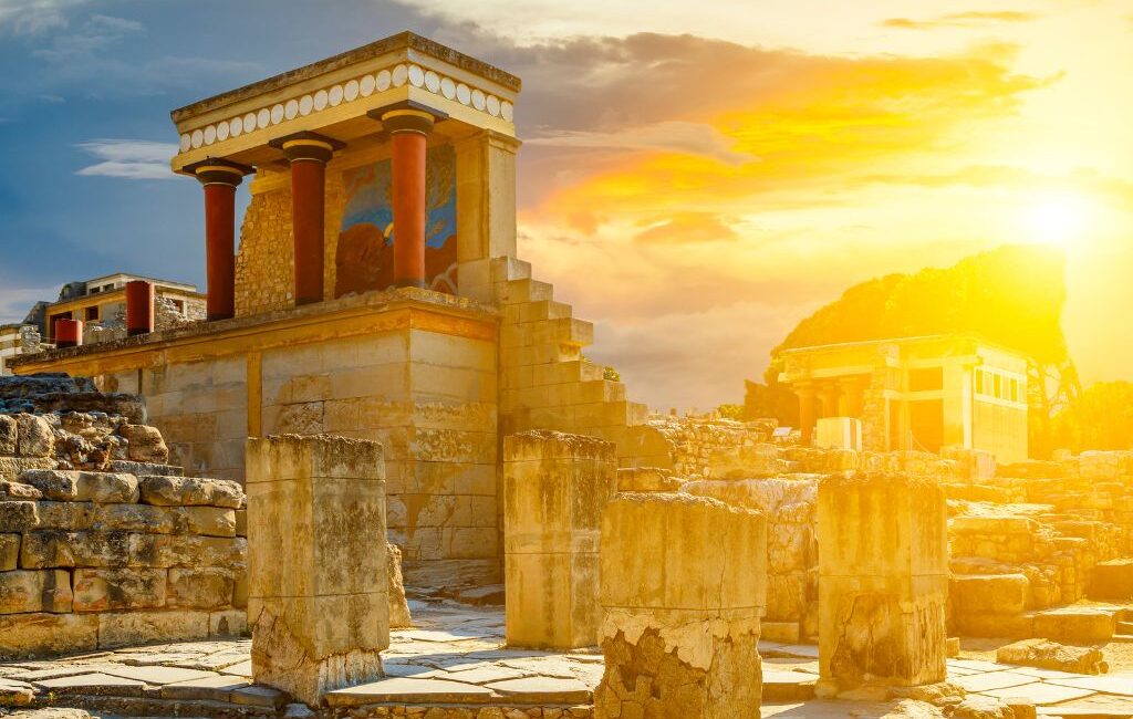 Palace of Knossos illuminated by the evening sun, showcasing ancient ruins and vibrant colors.