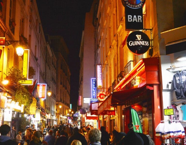 "LGBTQ community celebrating in the vibrant streets of Le Marais, Paris, showcasing the city's inclusive and diverse spirit.