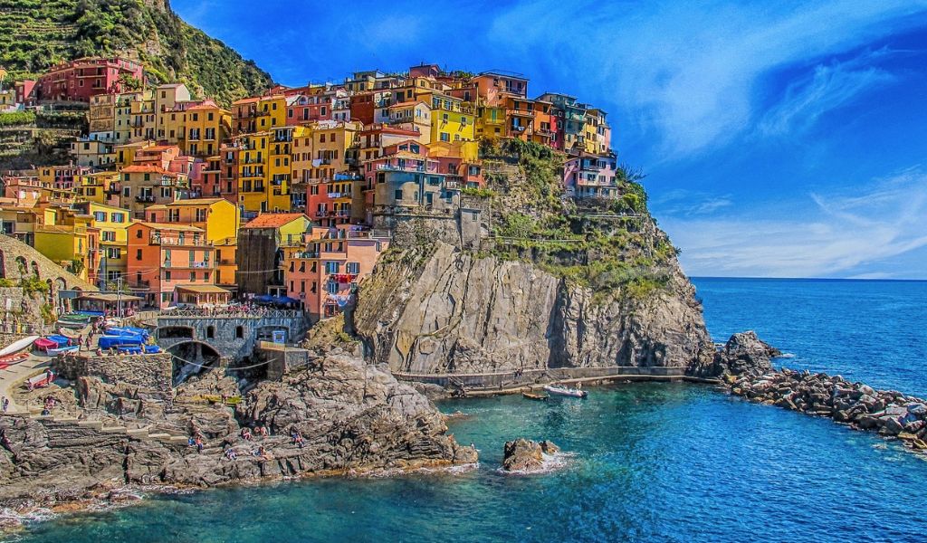 A vibrant village in Cinque Terre perched on cliffs above the Mediterranean Sea