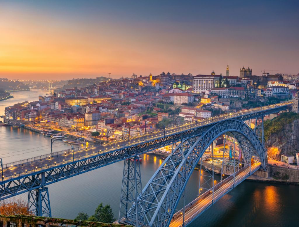 Evening view of Porto along the Douro River during a river cruise.