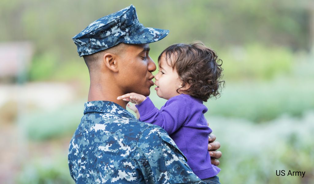 Soldier at Wiesbaden Army Base holding a small child