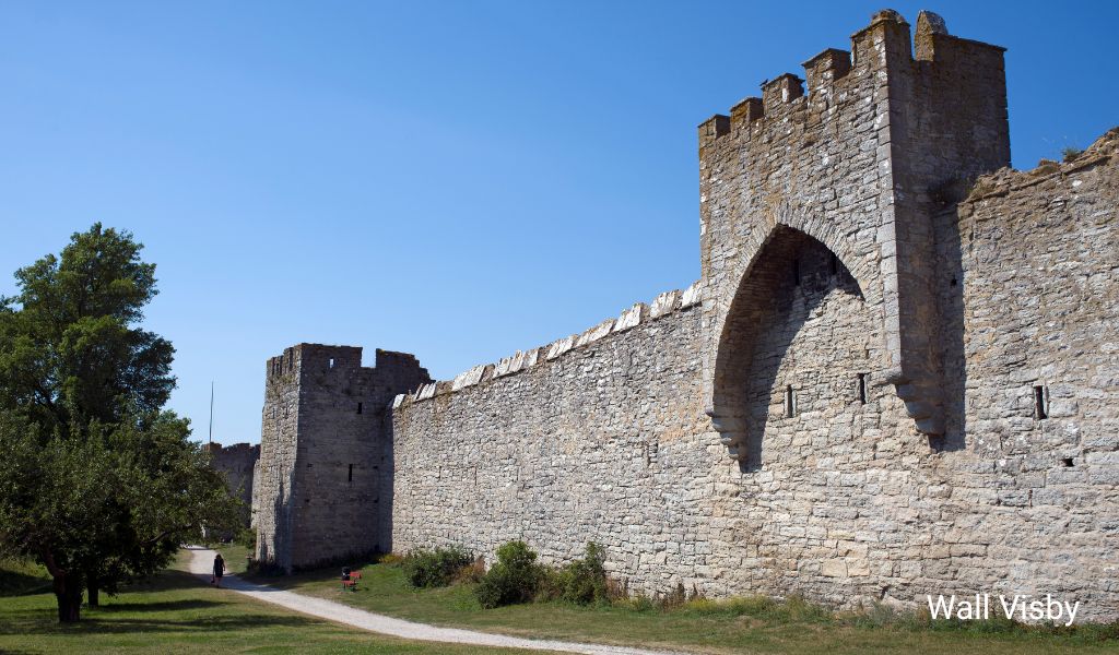 Historic city wall of Visby on Gotland Island, Sweden, surrounded by lush greenery and medieval architecture, highlighted in our Gotland beaches guide