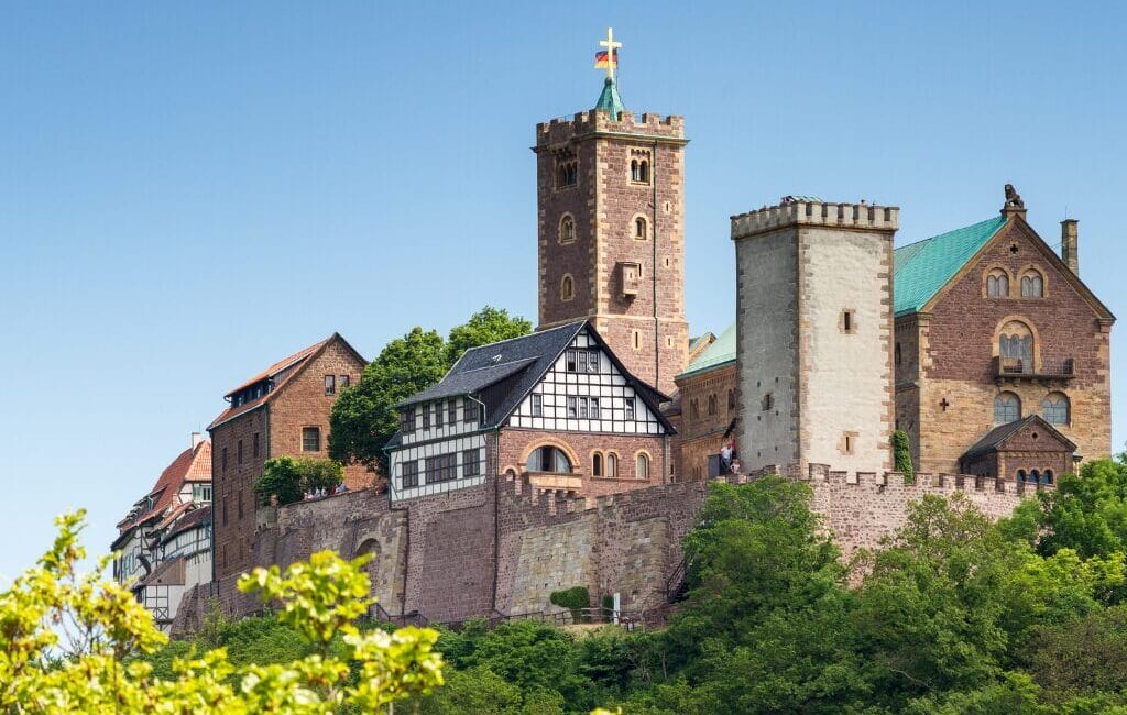 Wartburg Castle on a hill under a bright blue sky