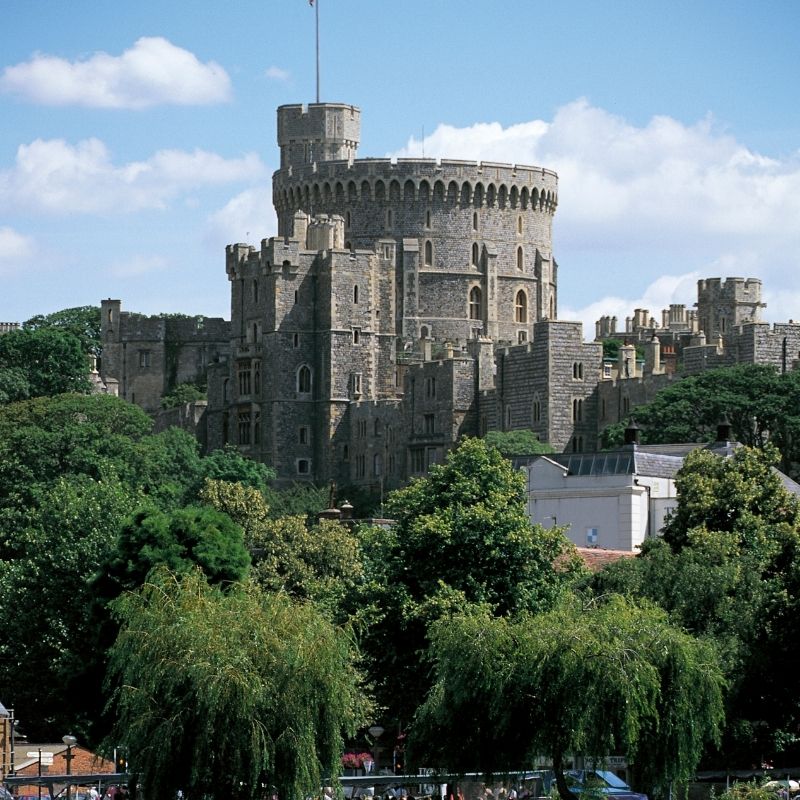 Windsor Castle, the historic royal residence in England, featuring its iconic towers and lush gardens.