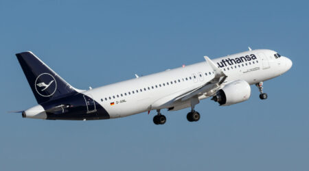 Lufthansa airplane on the runway, preparing for takeoff, showcasing the airline's distinctive blue and yellow livery.