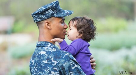 Soldier at Wiesbaden Army Base holding a small child