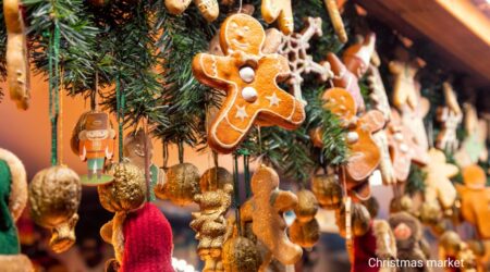 A festively decorated alley with string lights and Christmas decorations in a European city