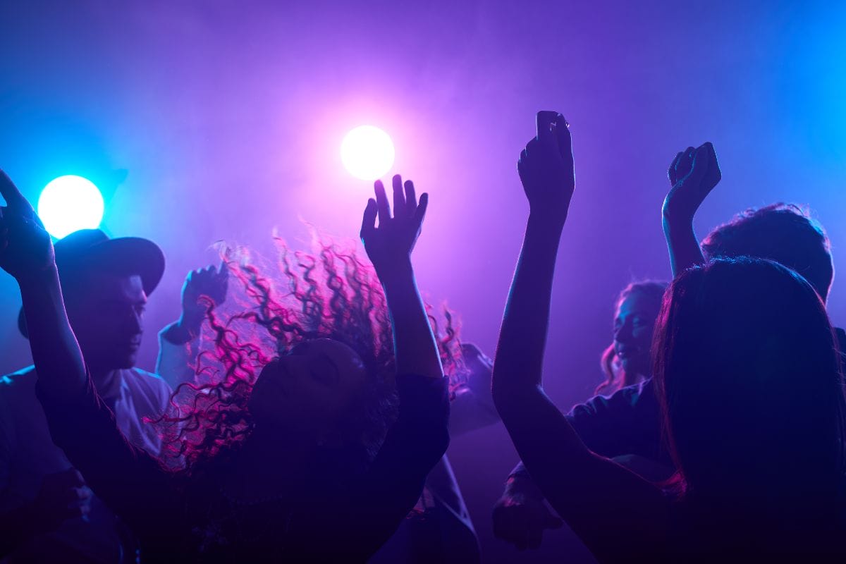 People dancing at a vibrant nightclub in Amsterdam.