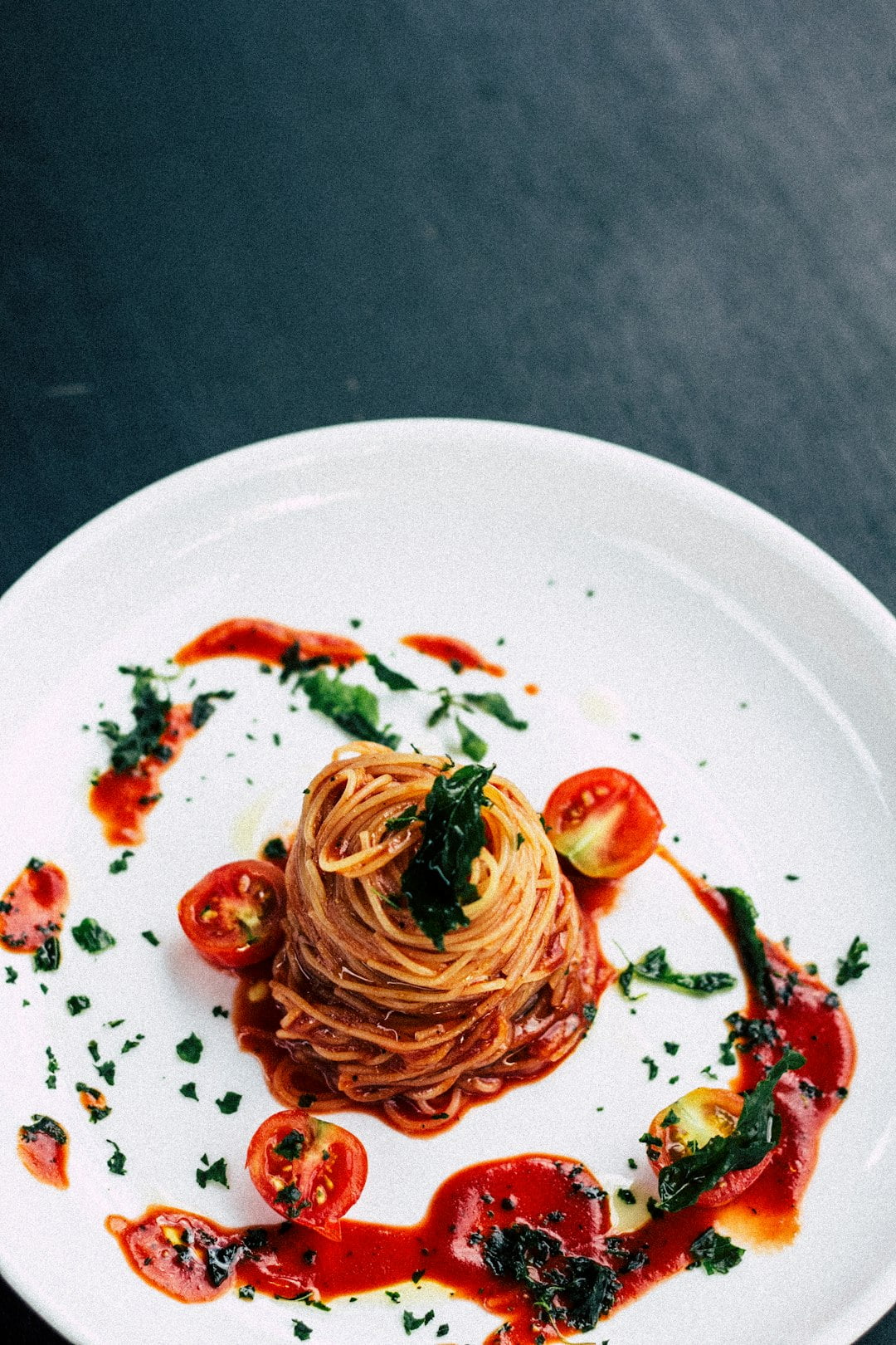 Beautifully arranged plate of spaghetti and tomatoes