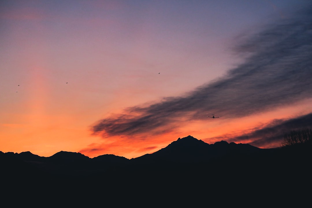 Shadows of the Alps illuminated by red evening light, symbolizing the conclusion of exploring Austria’s best ski villages.