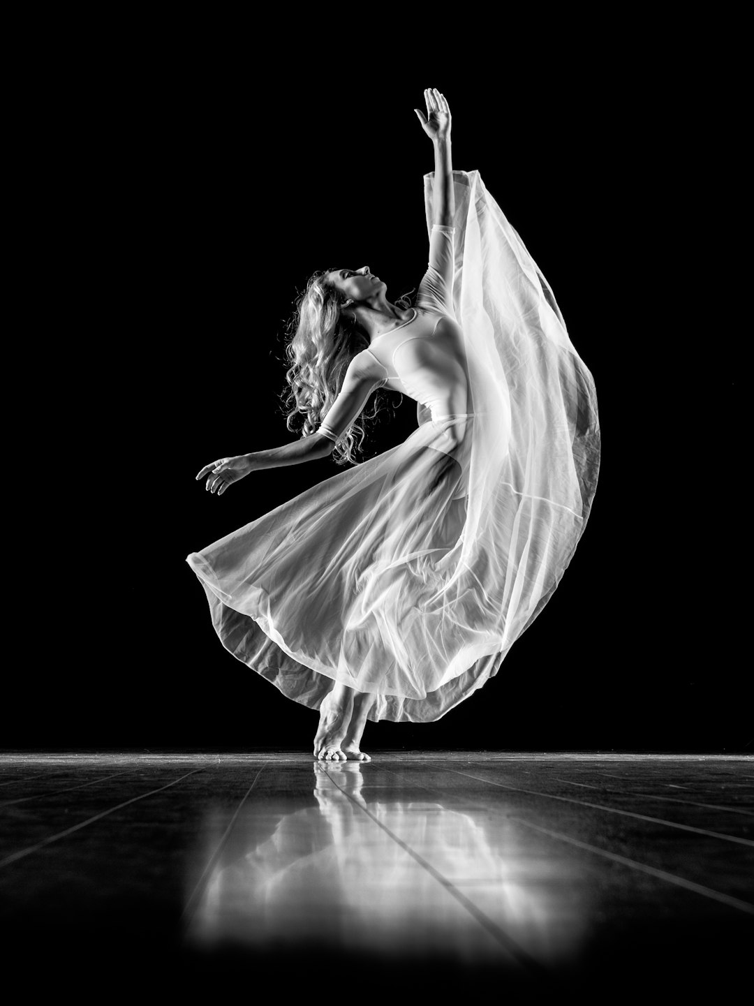 Black and white photo of a ballerina performing a graceful pose