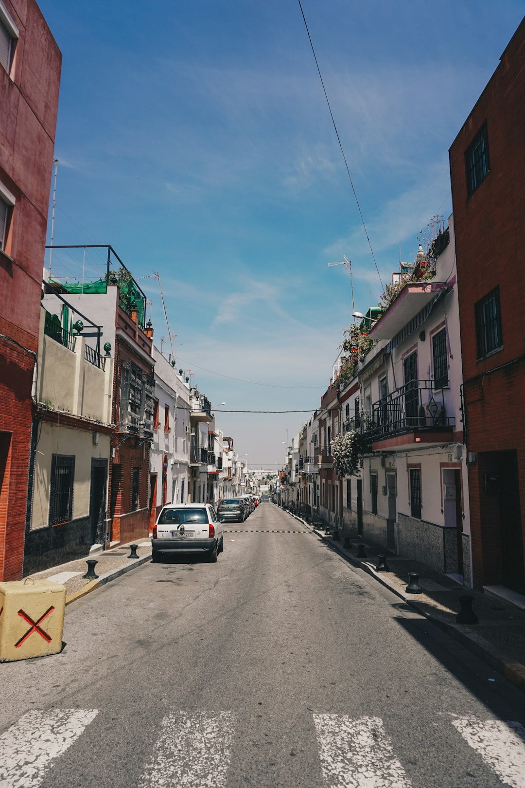 Old alleyway in a Spanish city, illustrating cultural contrasts in personal space and physical contact between Americans and Spaniards