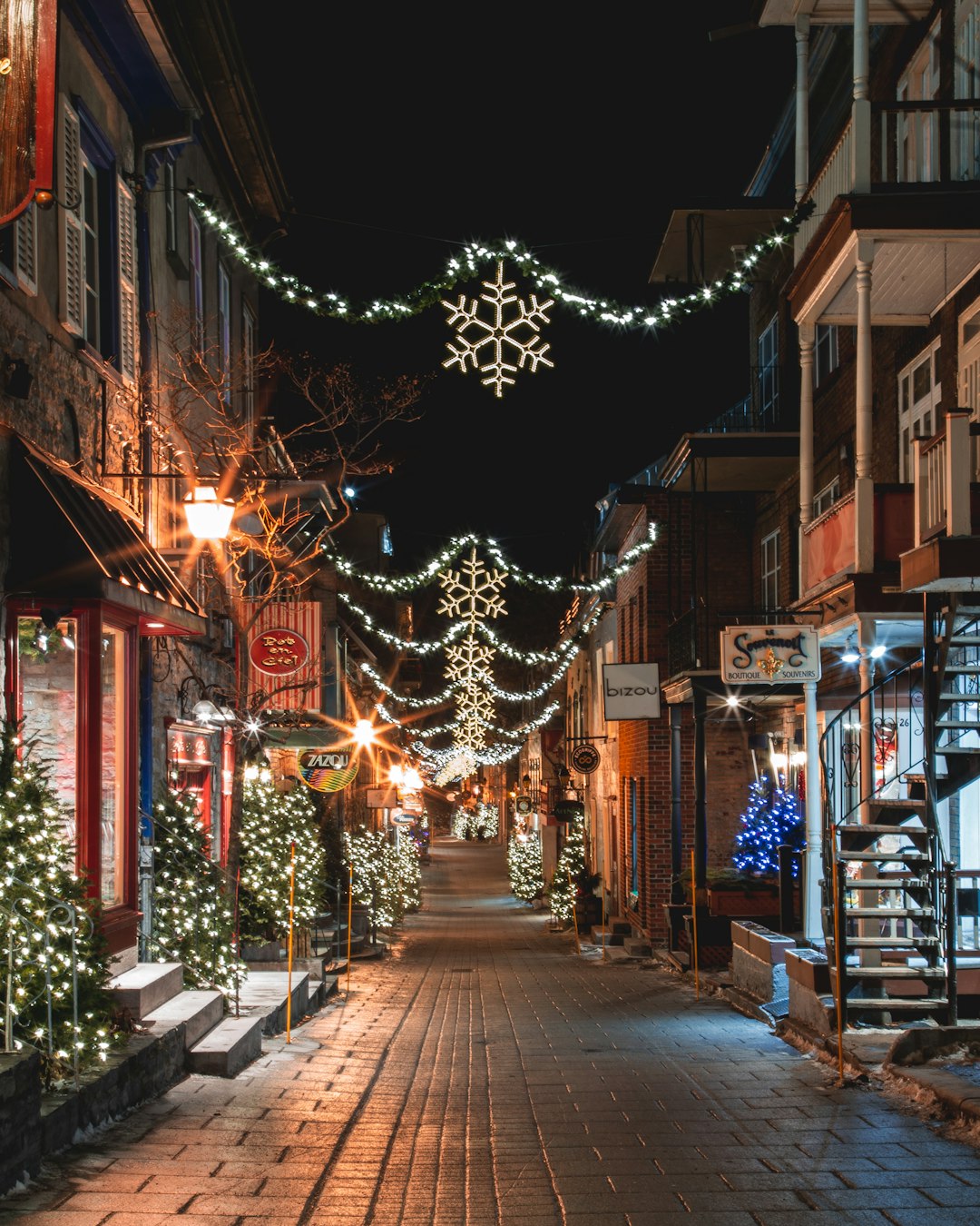 A festively decorated alley with string lights and Christmas decorations in a European city